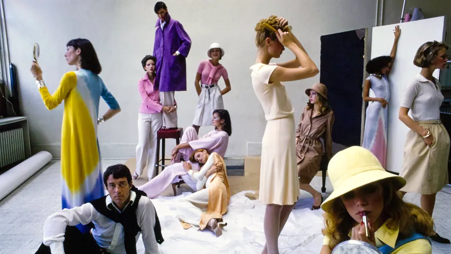 twelve people in a photography studio posing in different stances