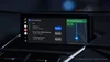 A car display shows a Zoom meeting schedule next to a route in Google Maps.