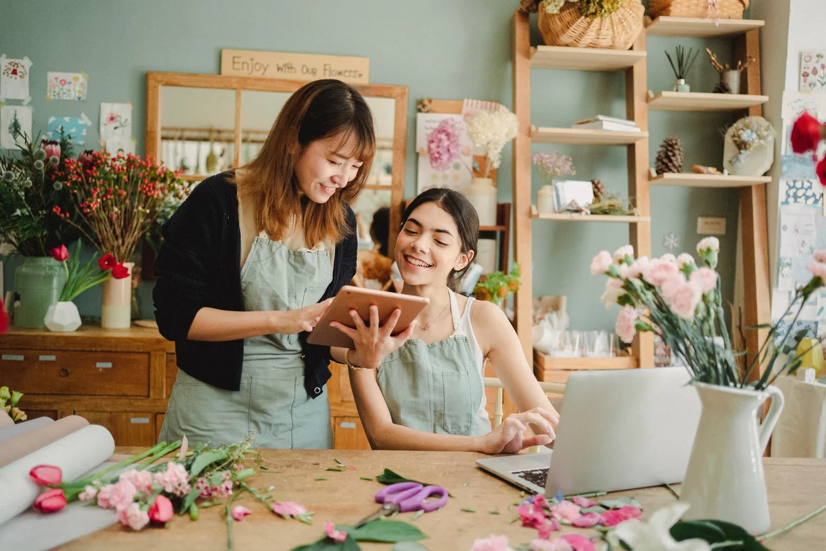 An image showing women working with a tablet in a floral-store