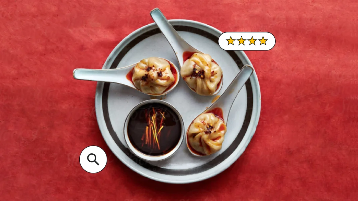 Soup dumplings on a plate with a red background, with icons suggesting ratings and search