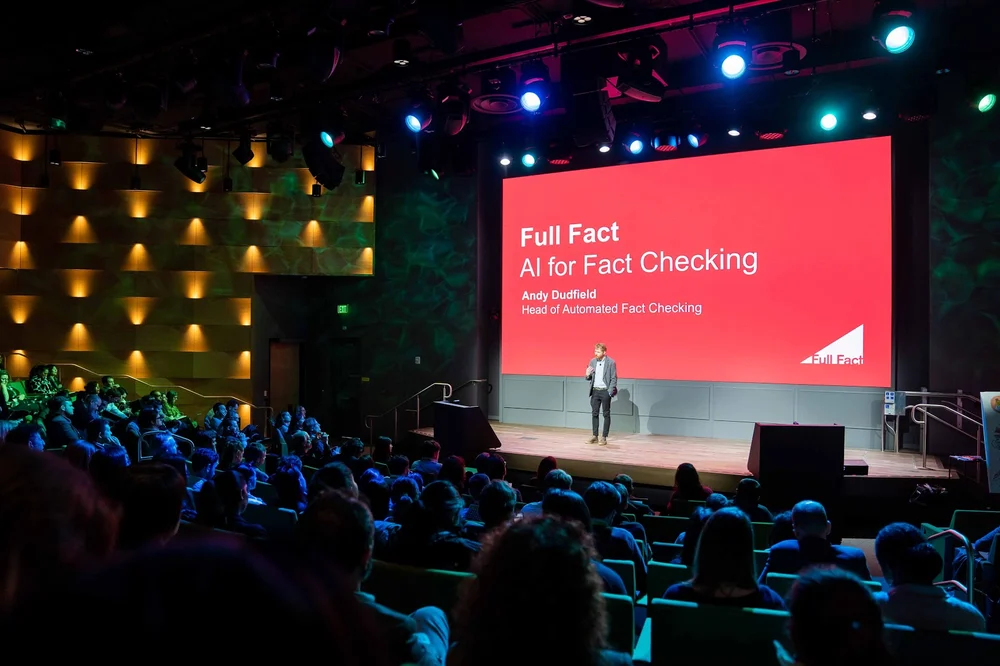 Image of a presentation given on stage about Full Fact and Google.org's work together.