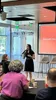 one female presenting in front of a room of people