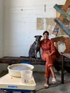 Gopi Shah seated with and her dog, Hanz, in their Long Beach Studio, next to her pottery equipment.