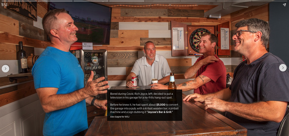 A man stands over a bar with three friends laughing and drinking beer. The text on the image reads: “Bored during COVID, Rich Joyce, left, decided to put a television in his garage for a no-frills hang-out spot. Before he knew it, he had spent about $5,000 to convert the garage into a pub, with a 4-foot wooden bar, a pinball machine and a sign dubbing it ‘Joycee’s Bar & Grill.’”