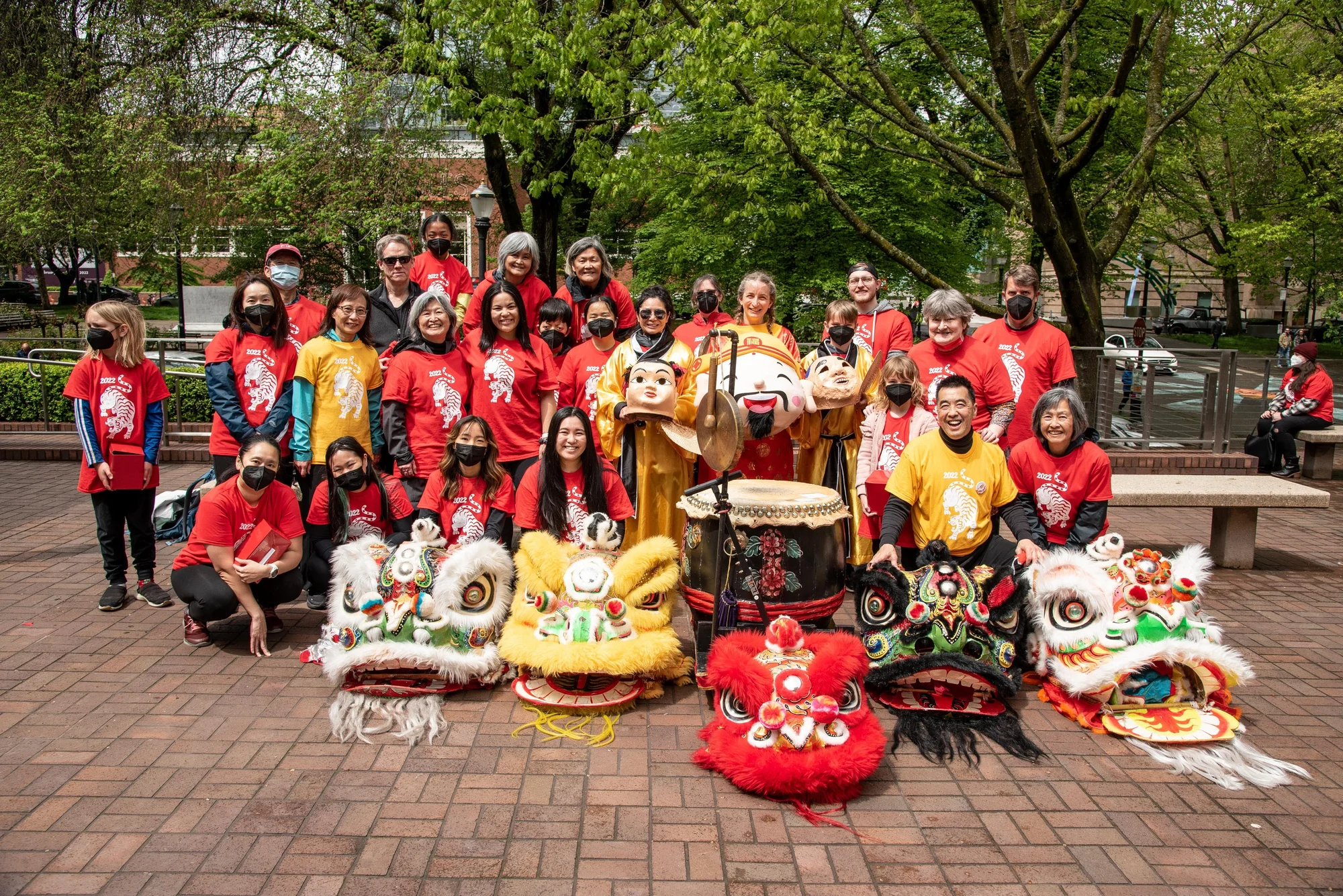 a group of people posing for a picture in a public park