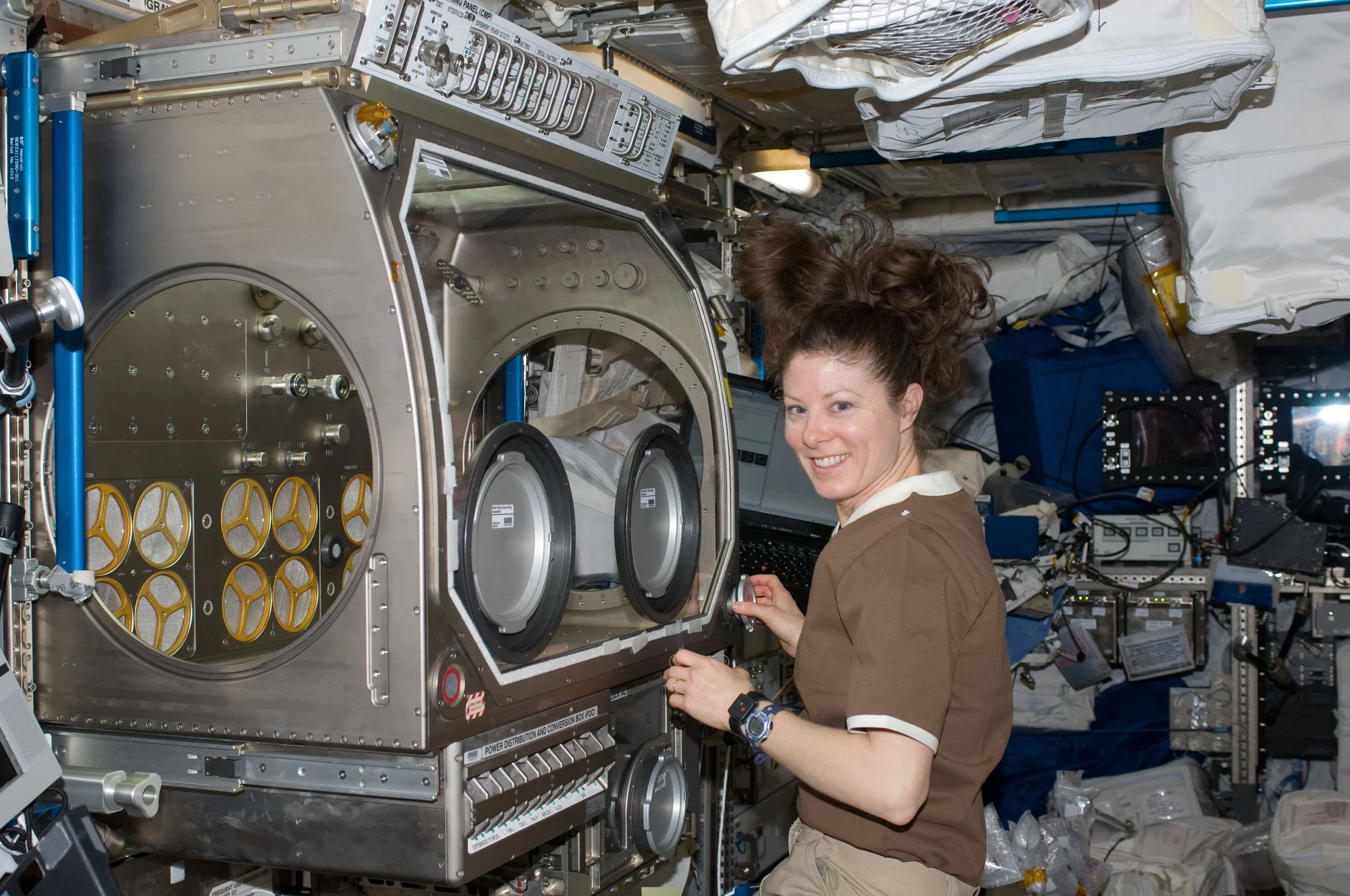 NASA astronaut Tracy Caldwell Dyson, Expedition 23 flight engineer, works with experiment hardware in the Microgravity Science Glovebox (MSG) located in the Columbus laboratory of the International Space Station.
