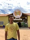 Aluno do Amigos do Bem posa pra foto na frente da Instituição.