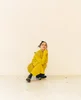 Musician Japanese Breakfast poses for the camera in a long yellow dress