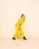 Musician Japanese Breakfast laughs in a long yellow dress