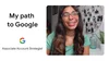 Screenshot from a video about Prisha's journey to Google. On the left are the words "My Path to Google" and "Associate Account Strategist" with a Google logo above it. On the right is a photo of Prisha smiling at the camera, wearing a teal top.