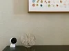 Nest camera on a table next to art objects