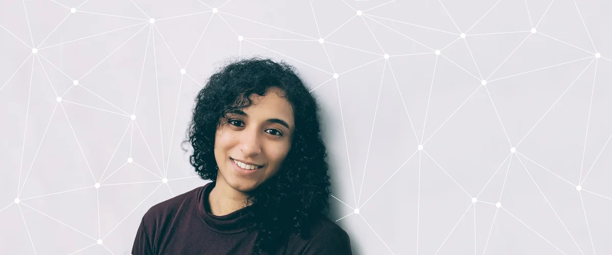 Image showing a photo of Maithra Raghu looking into the camera and smiling against an illustration background that represents the concept of neural networks.