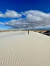 Man standing on sand dunes at White Sands National Park.