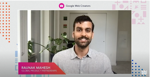 Raunak Mahesh is seated in front of the camera, with a green plant and white walls behind him.