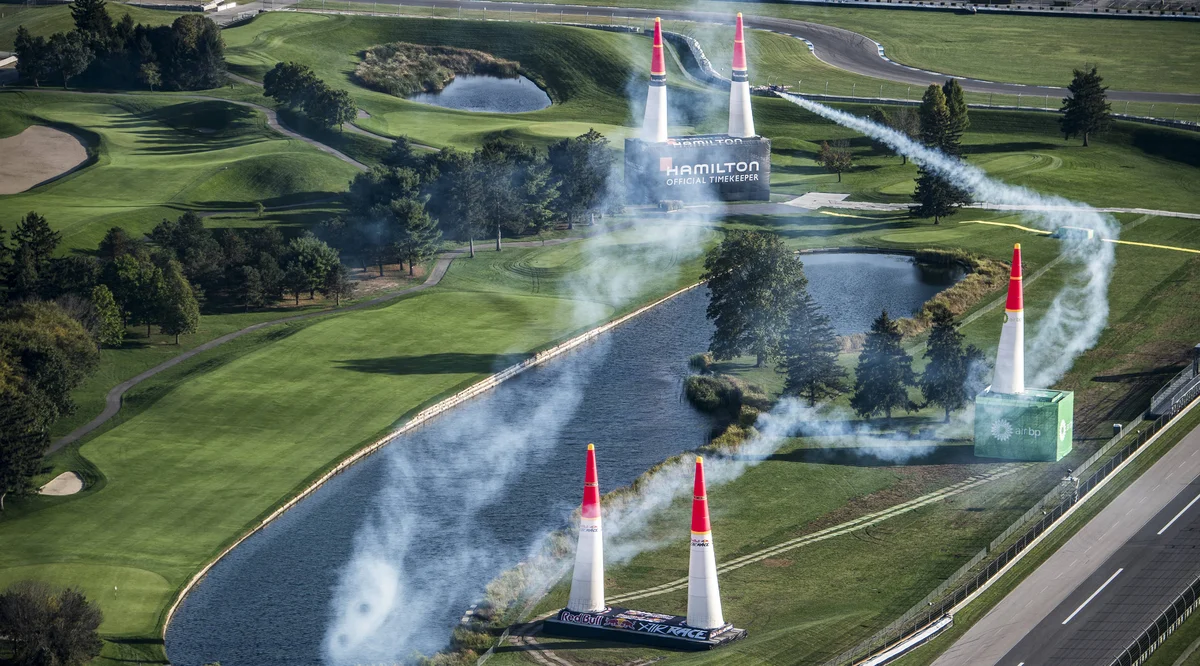 Smoke trails around cones as an aircraft takes flight