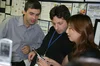 Google’s founders Larry Page and Sergey Brin alongside an employee at Google’s first Tokyo office. The Googler is demonstrating something on her phone.