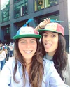 Luisa and teammate, Sarah, posing outdoors with Noogler hats.