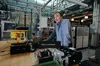 Dr. Leo Casey, Tapestry’s Chief Scientist, leaning over a desk with inverter hardware on it in the moonshot factory’s labs in Mountain View California