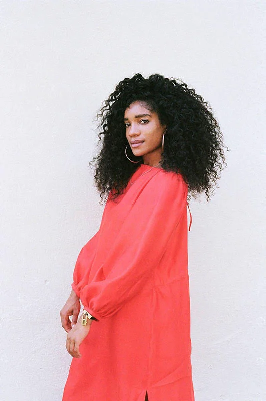 Photograph of Elyse Fox in a long red tunic