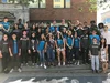 Group of students standing outdoors wearing CSSI shirts.
