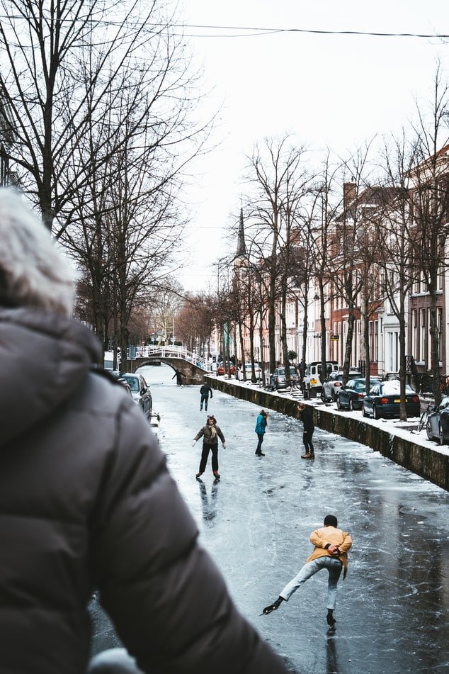 People ice skating on frozen canals.