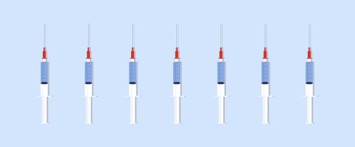 A line of syringes, representing potential vaccines