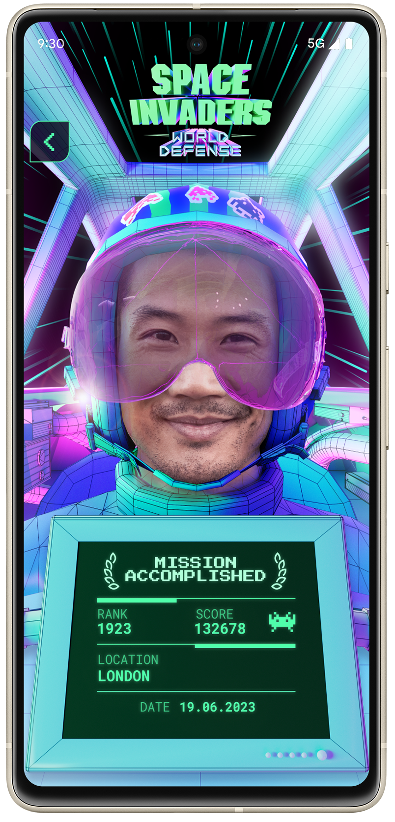 Japanese man taking an augmented reality selfie showing him as a pilot of the World Defense team and his rank and score he achieved in the game.