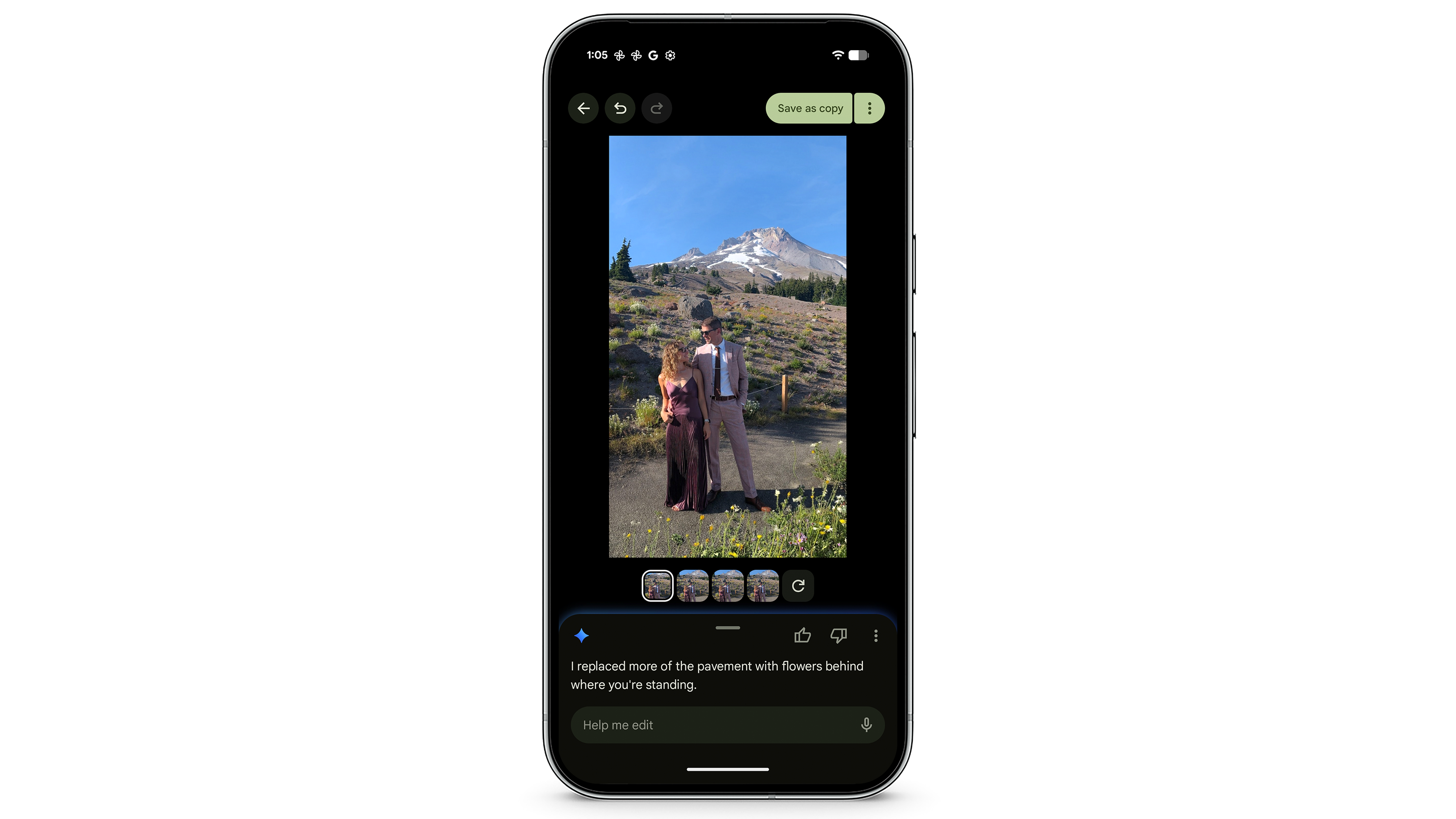 A smartphone screen displaying a photo editing application. The photo is of a man and a woman posing in front of a large, snow-capped mountain. An AI suggestion box at the bottom reads, I replaced more of the pavement with flowers behind where you're standing.