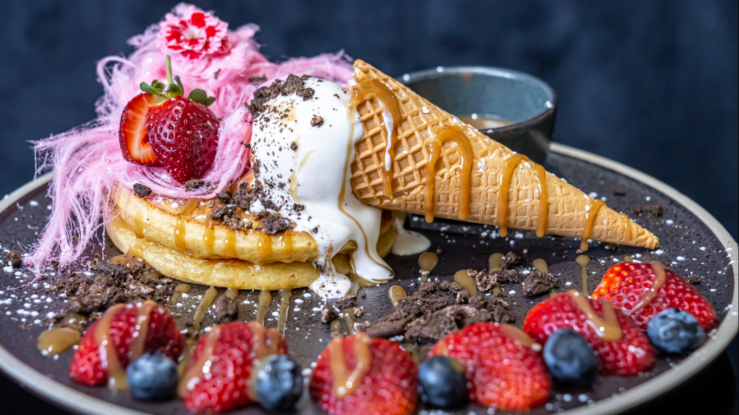 Photo of vibrant dessert with icecream and berries, by Andonis Cafe and Bar