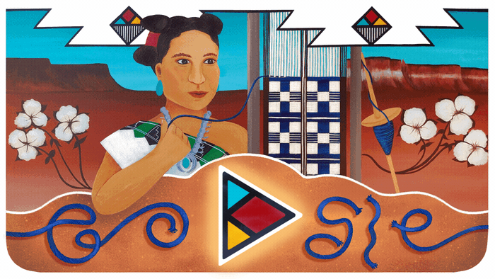 A still image of the 2021 Native American Heritage Month Google Doodle illustrating  a portrait of the late We:wa weaving a fabric pattern in front of a scenic blue and brown background.