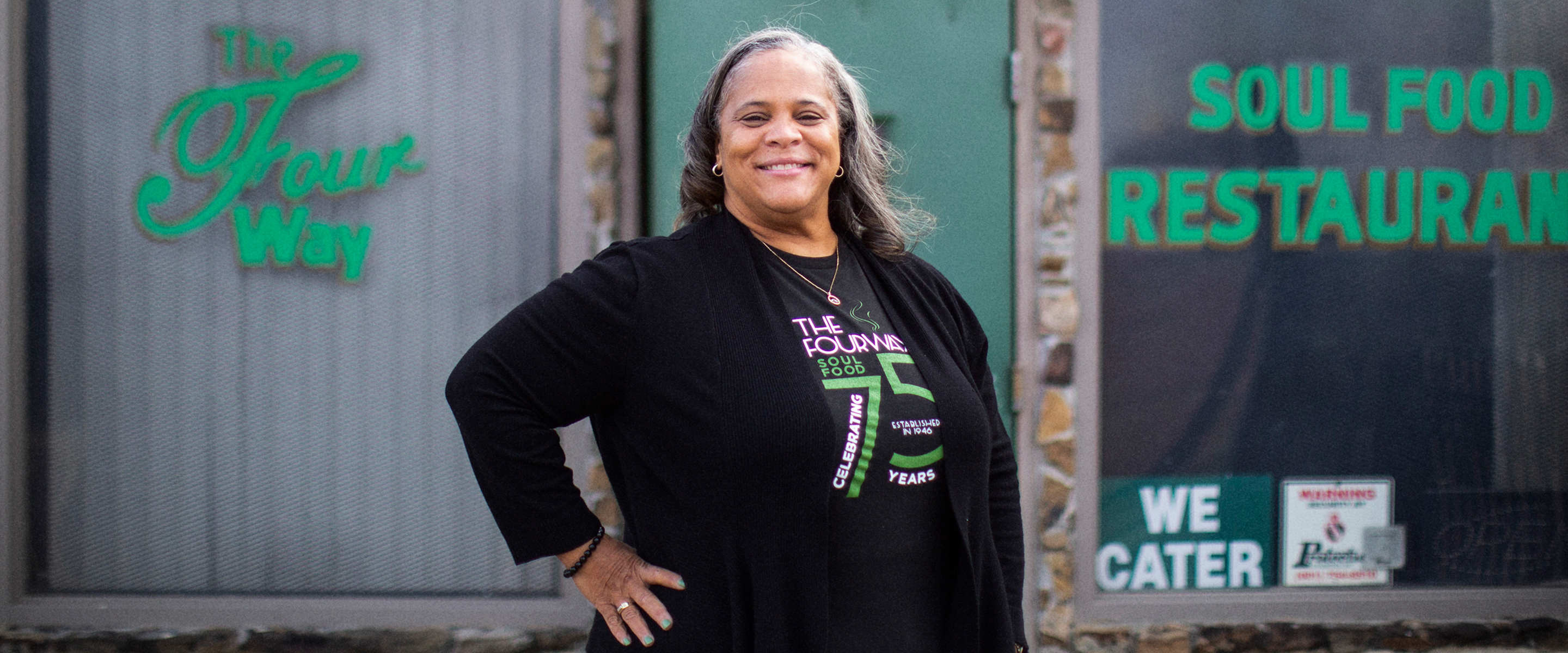 A woman standing in front of The Four Way Restaurant in Memphis