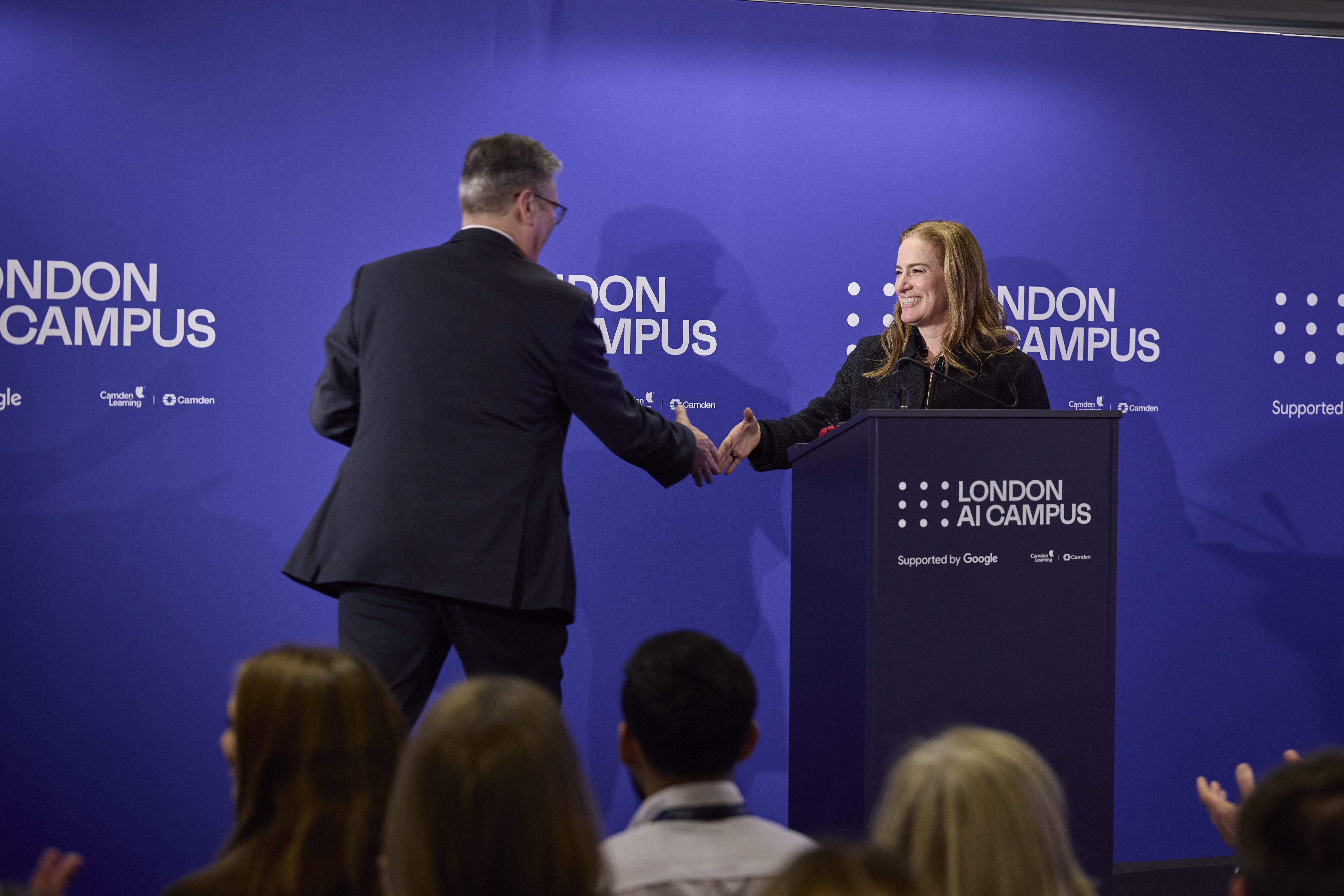 Photo of Debbie Weinstein and Keir Starmer on a stage