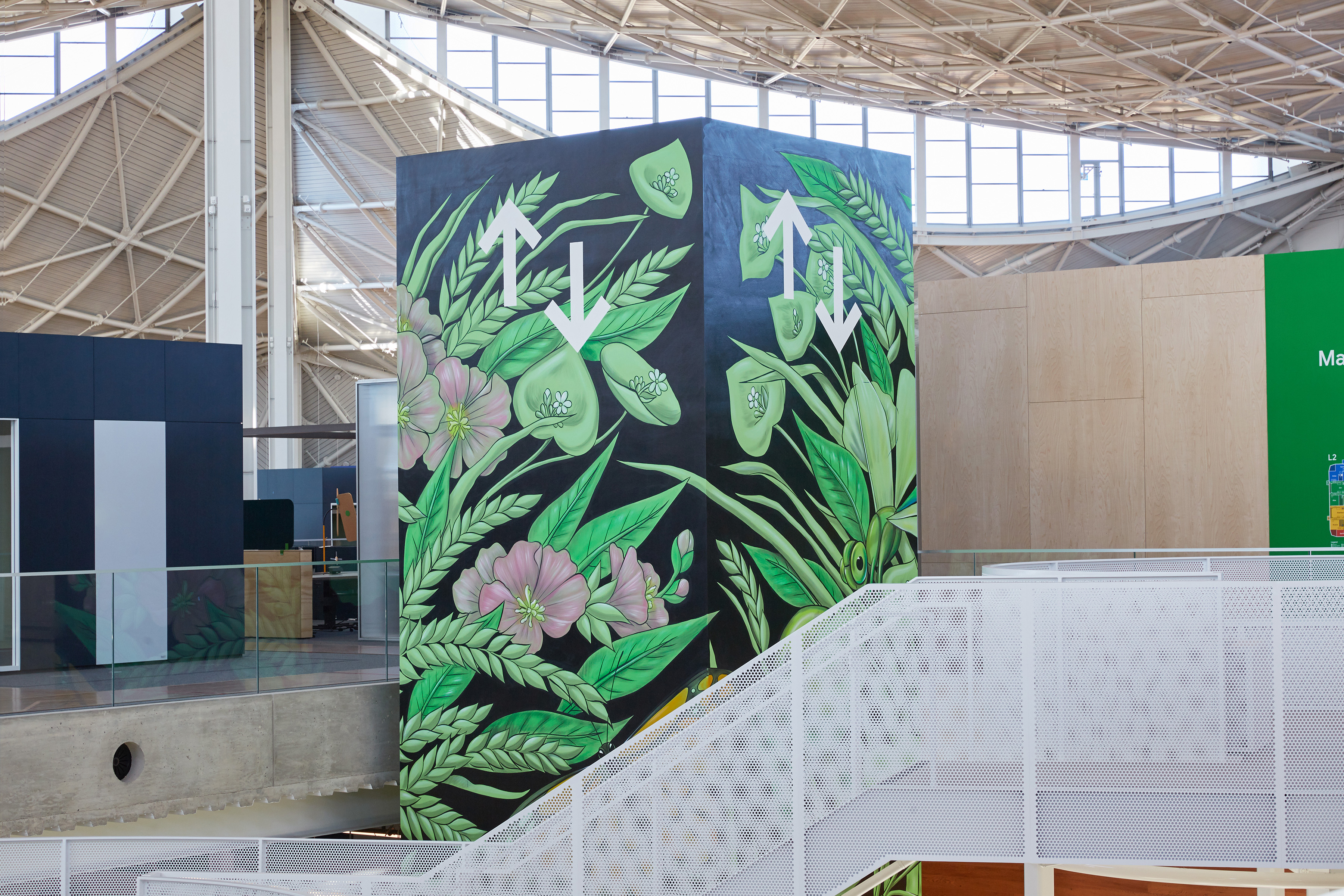 A photograph of Amandalynn's elevator mural, which has a black background with green plants and red and pink flowers as well as butterflies.