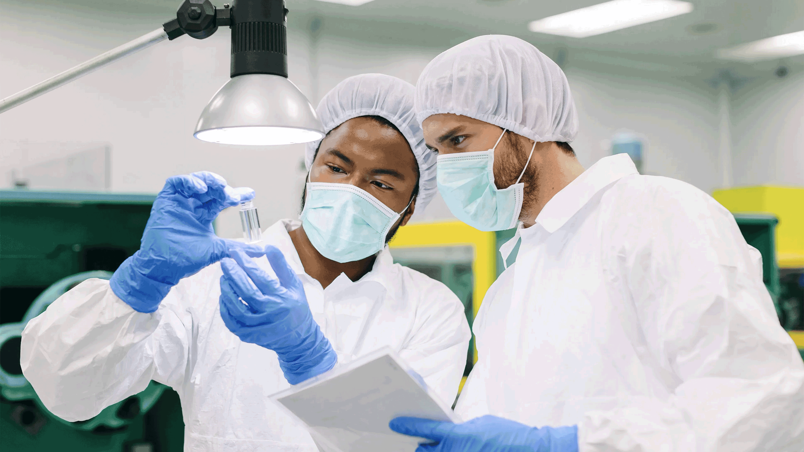 Two scientists working in a laboratory with protective gear