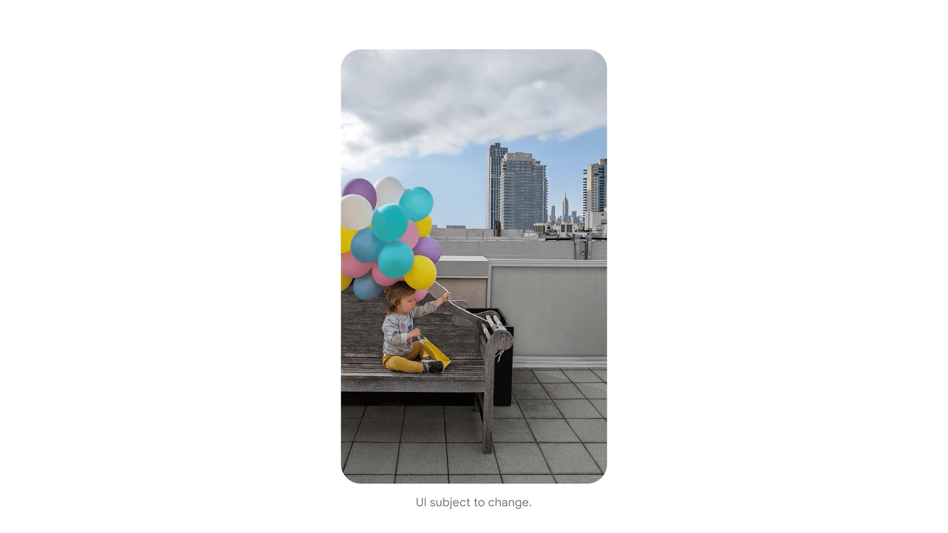 An animation of a toddler-aged boy on a bench on a rooftop, holding a bunch of colorful balloons, with a city skyline in the background. In the shot on the right the boy is centered, you see more of the bench and balloons and the sky is clearer.
