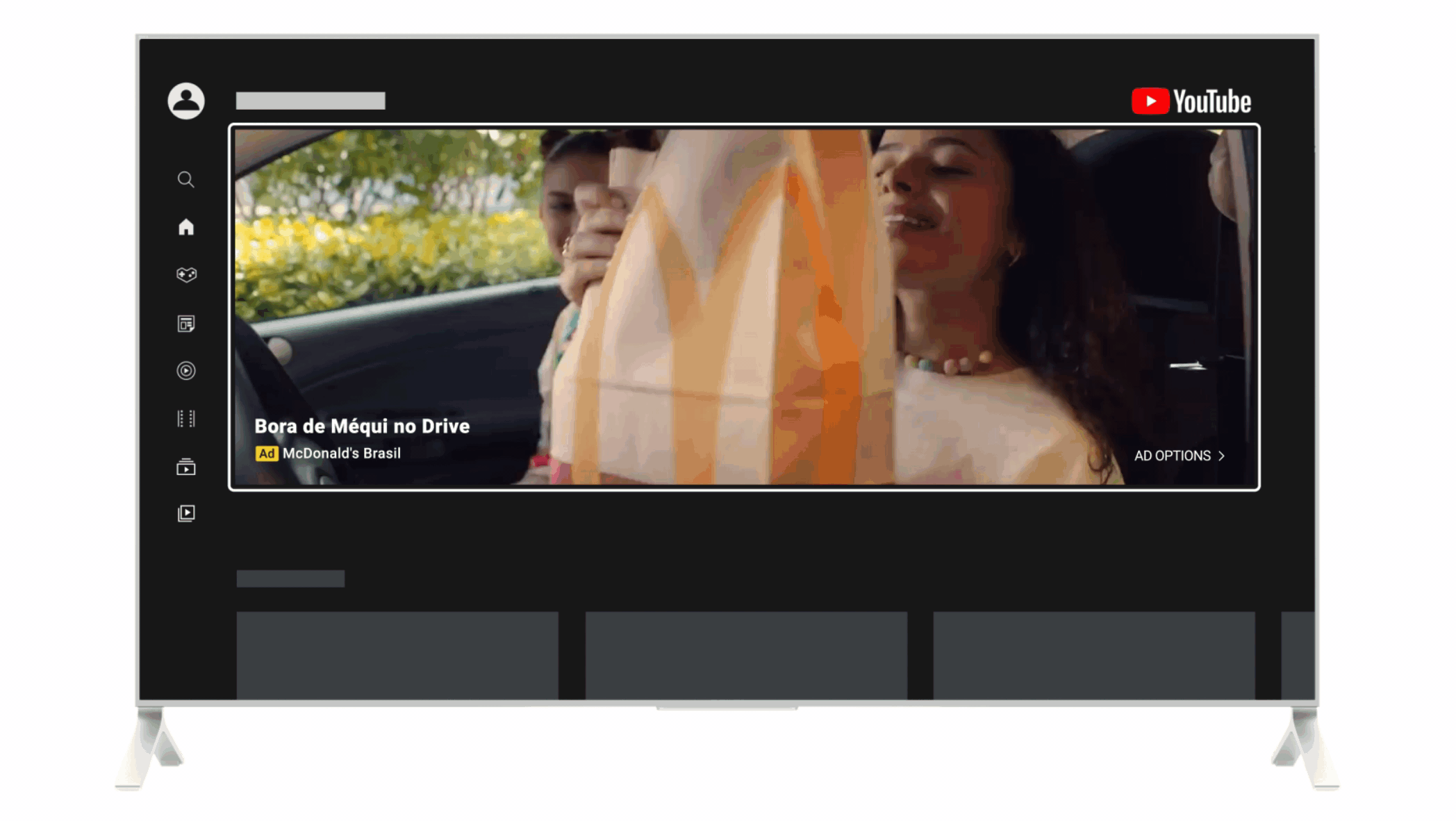 A TV displays a McDonald’s ad playing on YouTube’s homepage. The ad shows two women ordering at a McDonald’s drive thru.