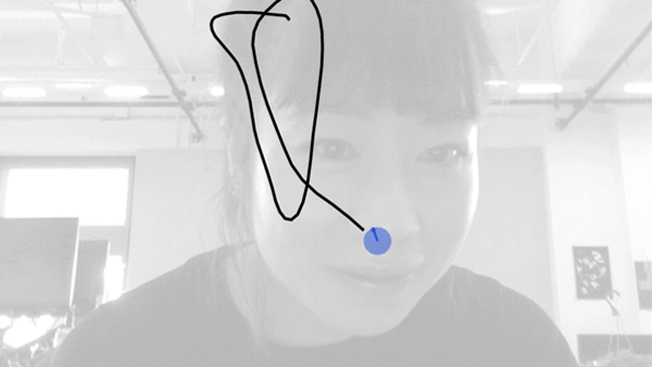Animated GIF of blue cursor tracking a woman's nose. As she moves, she draws lines with the cursor demonstrating drawing with camera tracking on the nose.