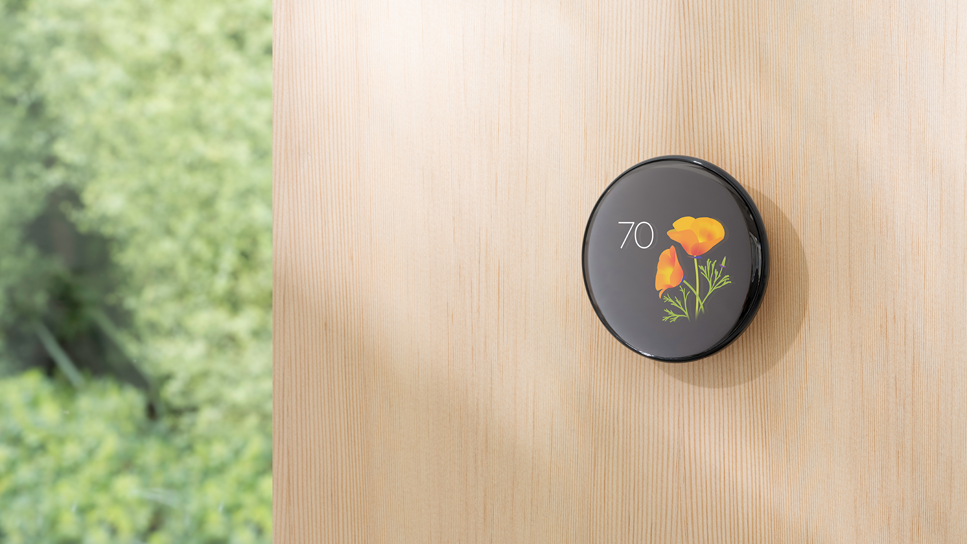 A lifestyle image of the Nest Learning Thermostat (4th gen) featuring one of the new seasonal Farsight faces.
