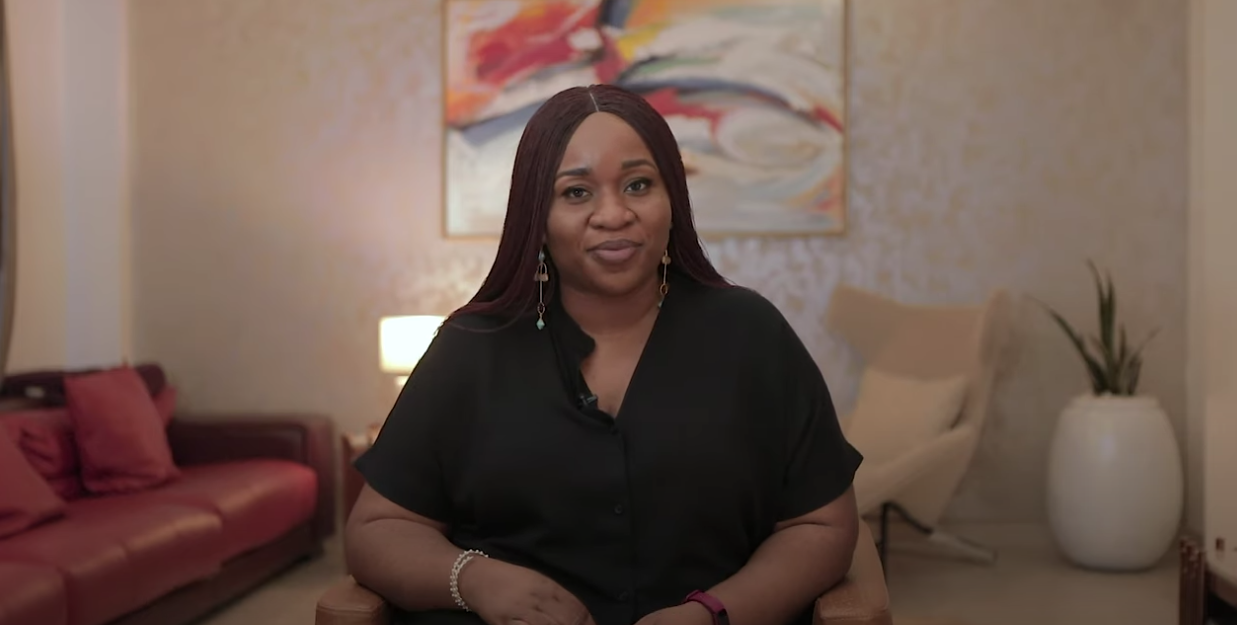 A video interview with Onajite set against a plain background in her home