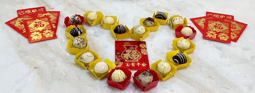 Chocolate and sweet desserts in the shape of a heart surrounded by red