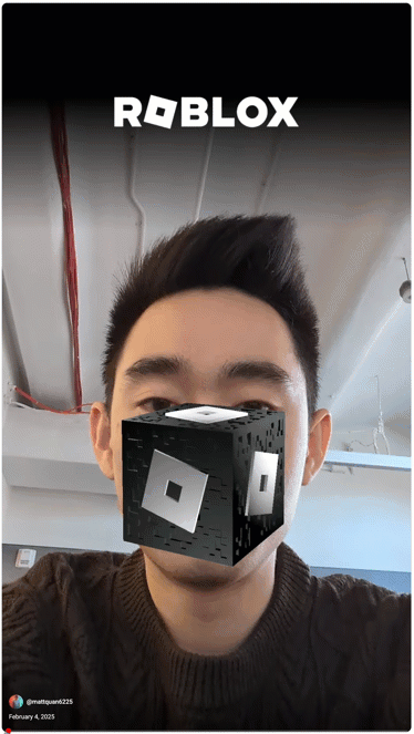 A person uses the "Roblox Vault" effect in YouTube Shorts, which overlays a digital Roblox cube with a white "R" logo over their nose. The official Roblox logo is visible at the top of the screen.