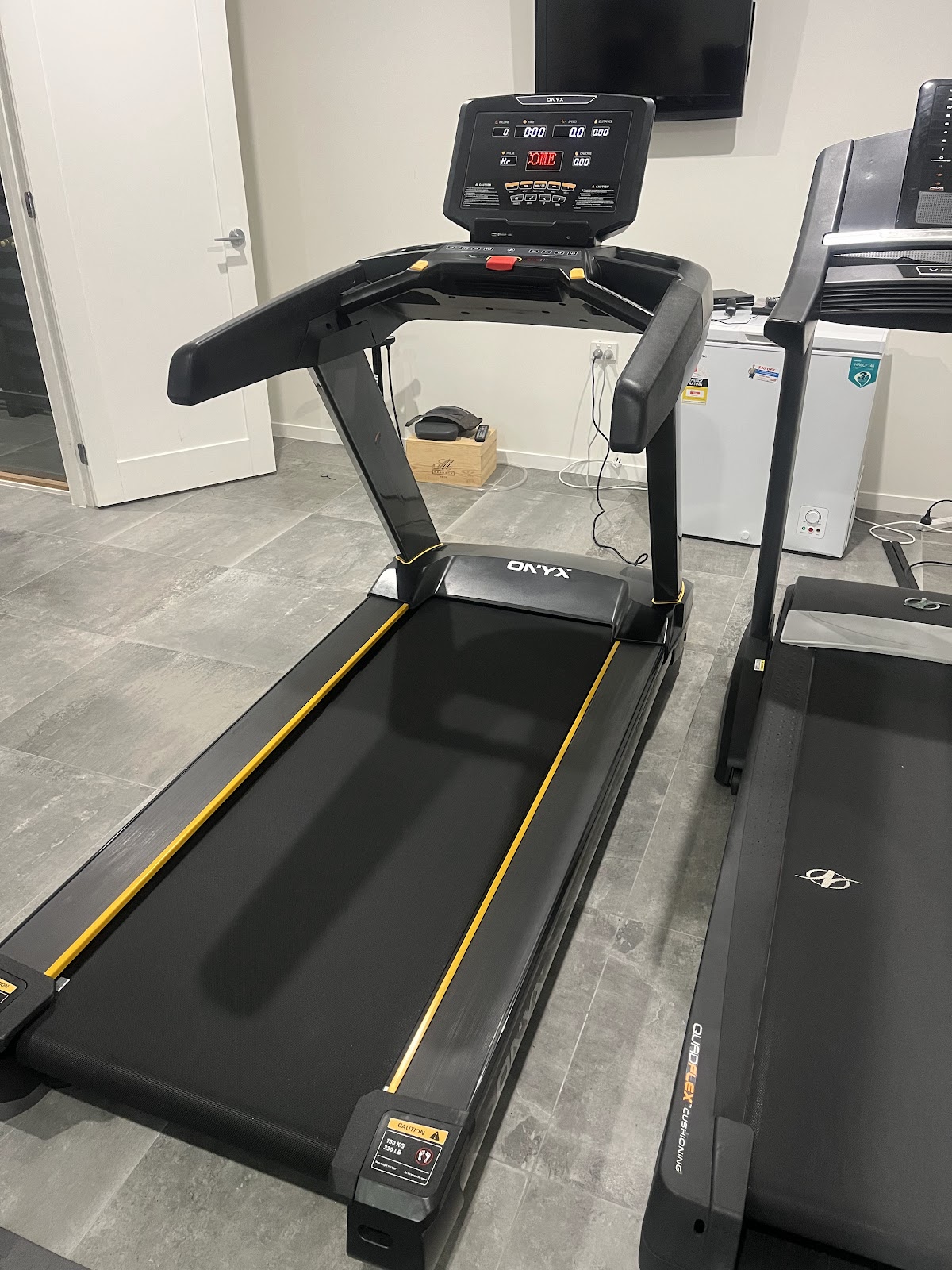 A close-up shot of a treadmill in what appears to be a gym or fitness studio.
