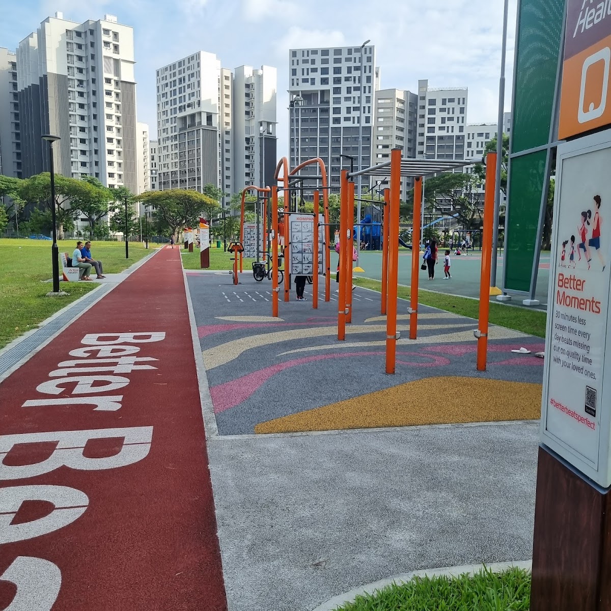 An outdoor fitness area with pull-up bars and a running track is visible against a backdrop of urban buildings.