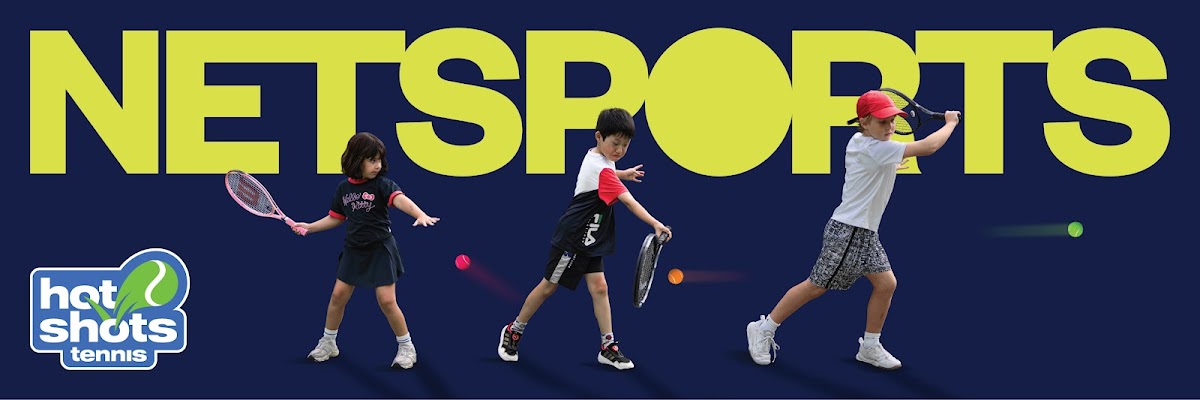 Three young children are participating in a tennis lesson with rackets and balls.