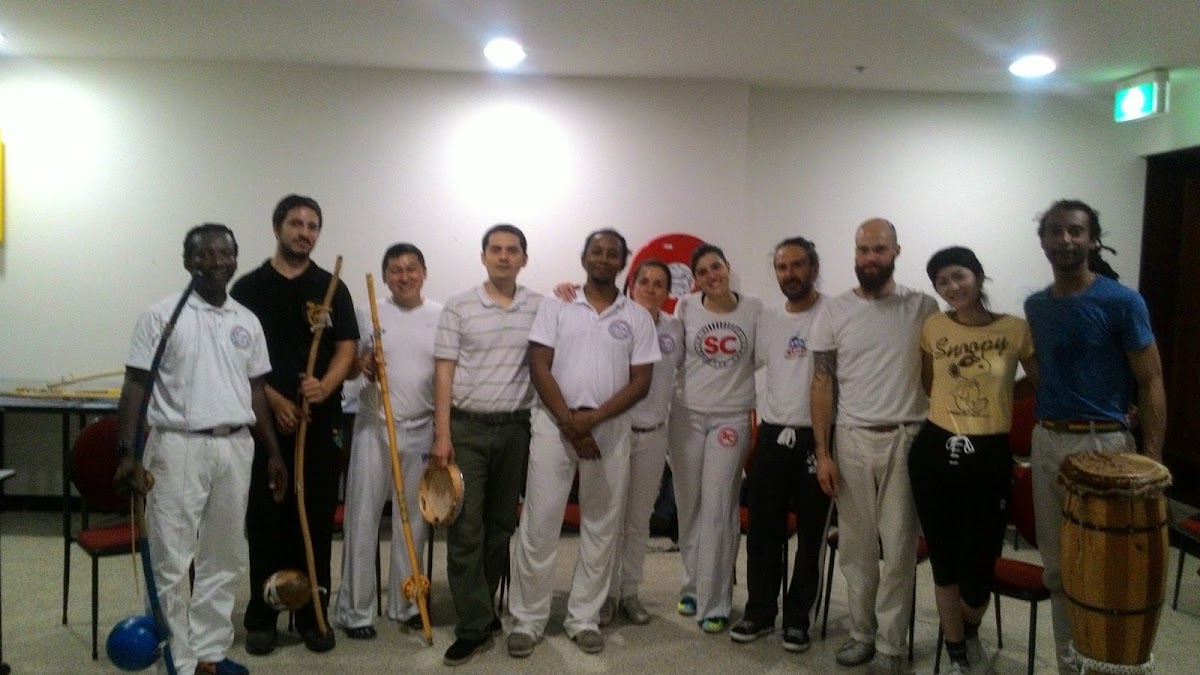 A group of people are posing for a photo in what appears to be a training session or class.