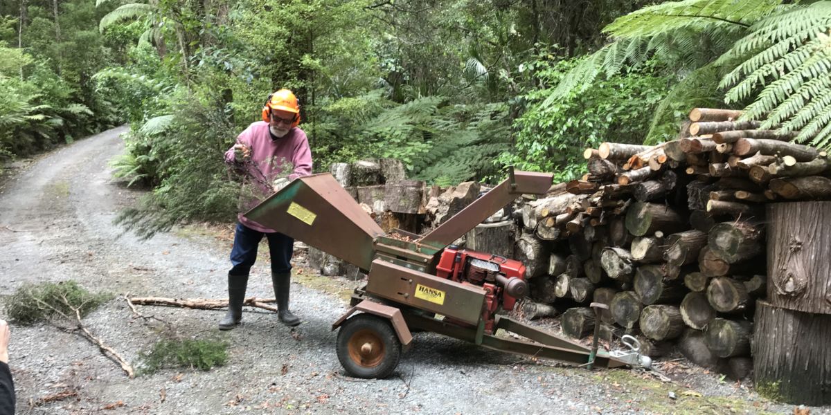 Man using wood chipper.