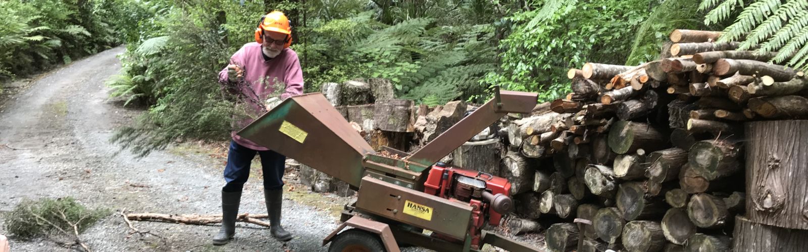 Man using wood chipper.