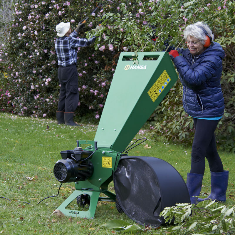 Woman using garden wood chipper