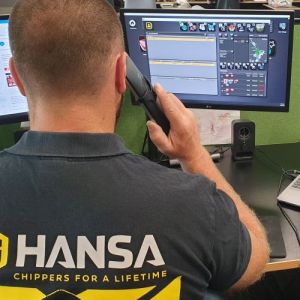 Hansa customer service rep sitting infront of their computer answering a telephone in the logistics office