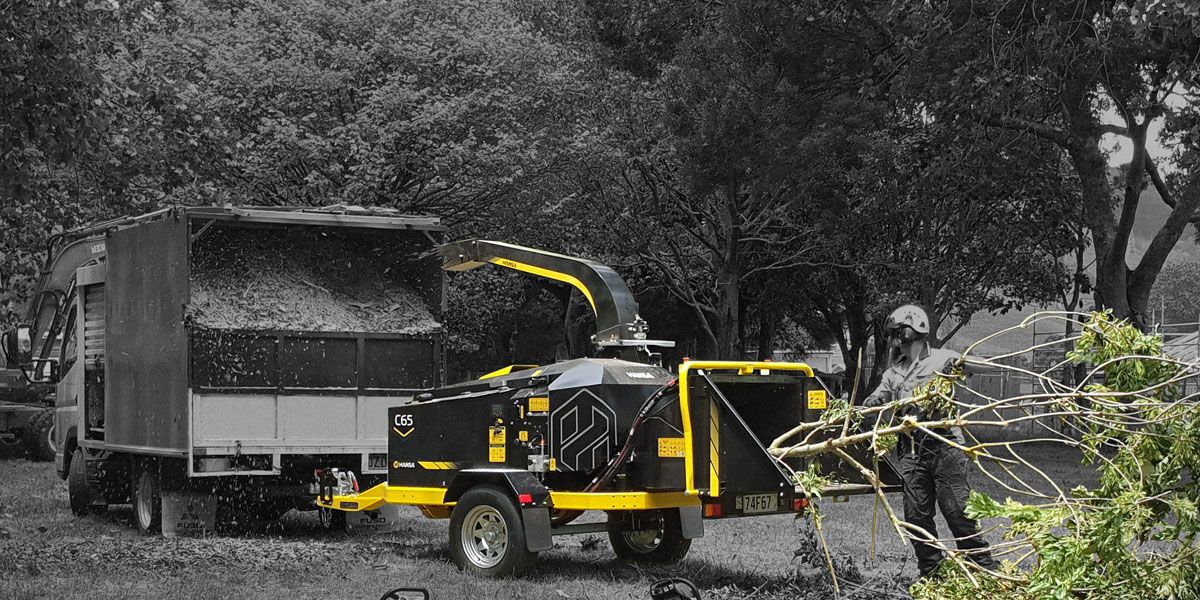 A C65 Hansa wood chipper highlighted in colour against a black and white background